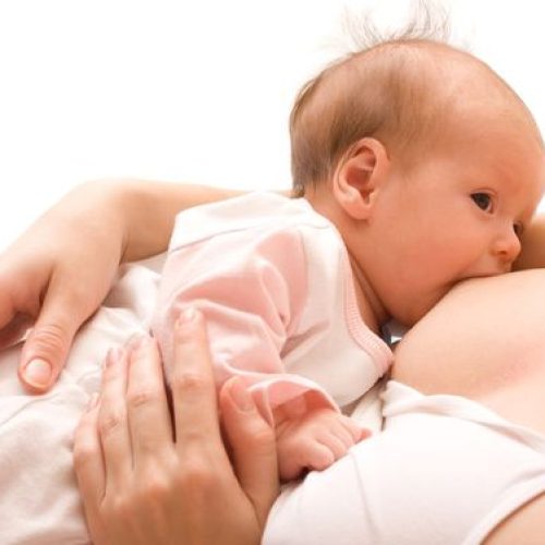 Breastfeeding. Young mother and 1.5 month baby